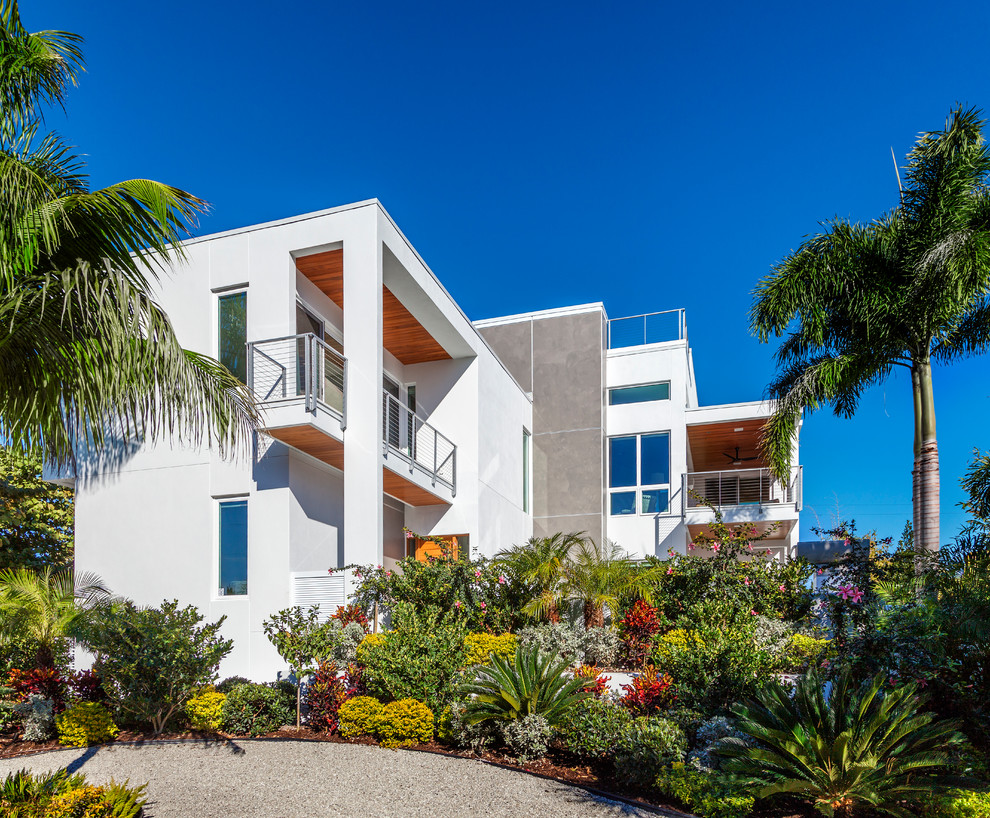 Photo of a large modern two-storey stucco white house exterior in Tampa with a flat roof.