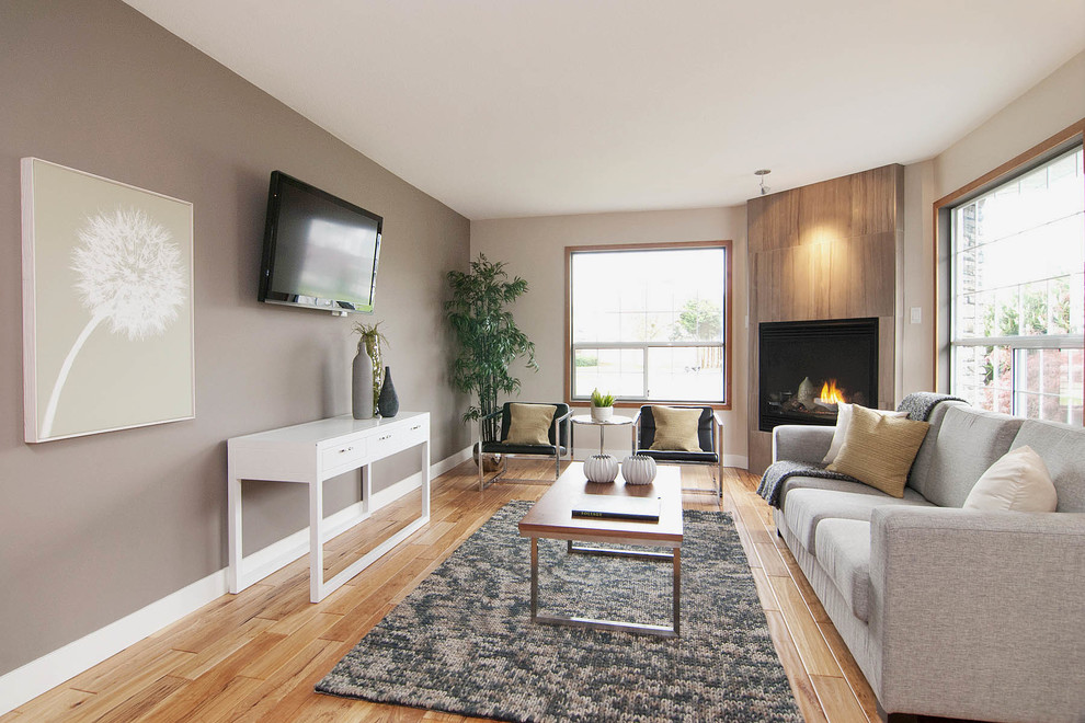 Design ideas for a contemporary family room in Vancouver with a corner fireplace.