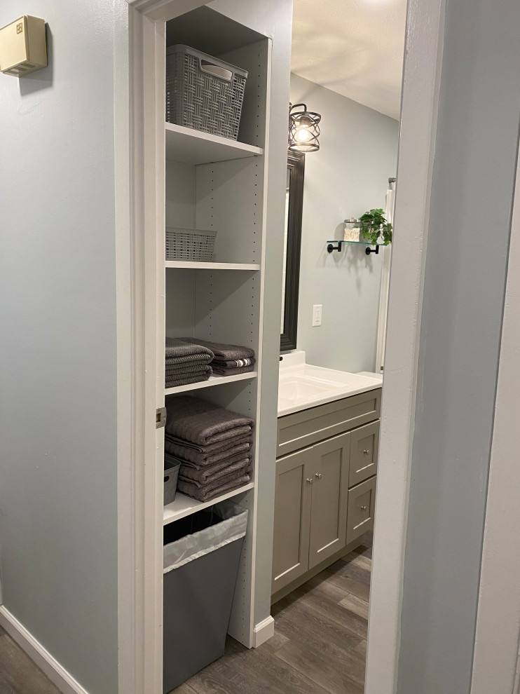 Example of a large transitional l-shaped vinyl floor and gray floor open concept kitchen design in Cincinnati with an undermount sink, raised-panel cabinets, white cabinets, granite countertops, multicolored backsplash, ceramic backsplash, stainless steel appliances, an island and black countertops