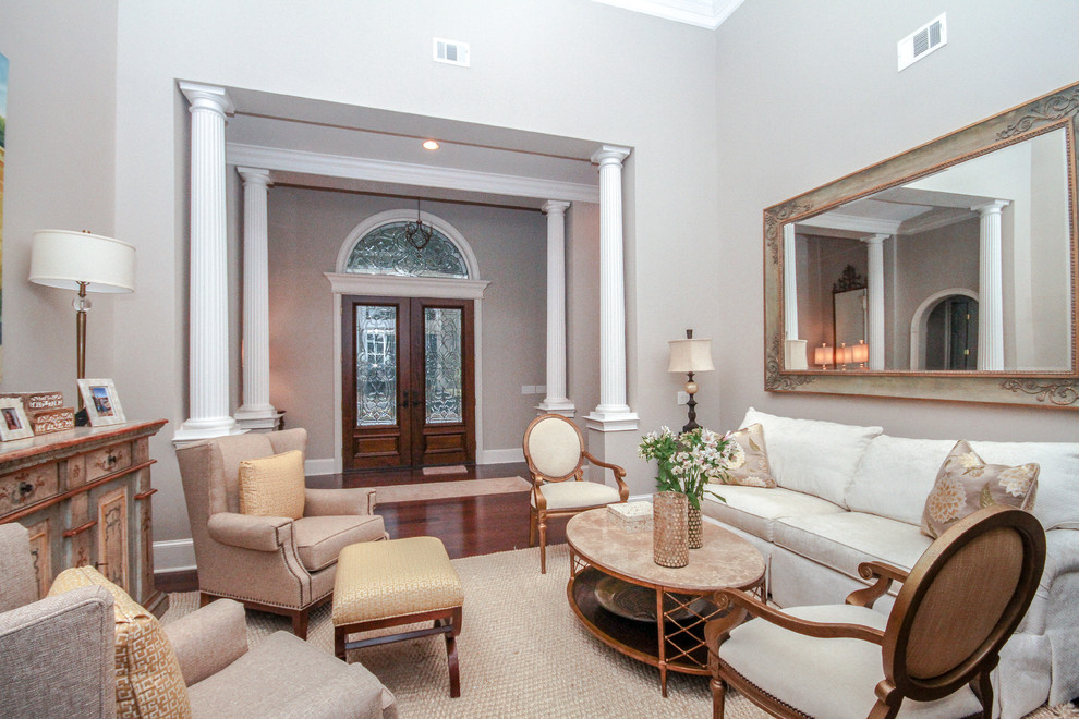 Photo of a mid-sized transitional formal enclosed living room in Atlanta with grey walls, medium hardwood floors, no fireplace and no tv.