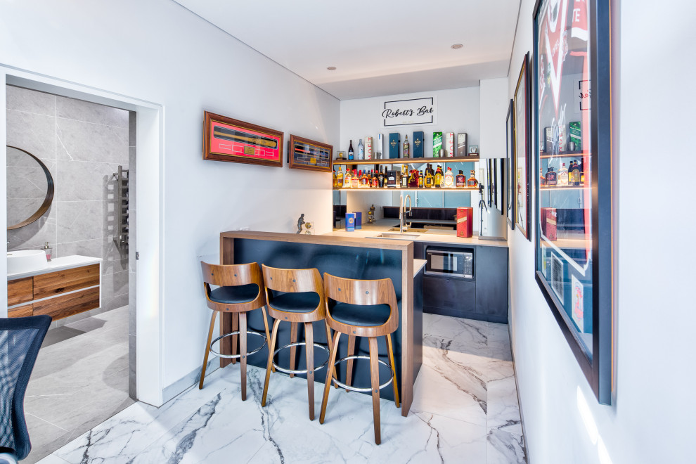 Inspiration for a large contemporary galley wet bar in Sydney with an integrated sink, all styles of cabinet, all types of cabinet finish, marble worktops, glass sheet splashback, terracotta flooring, white floors and beige worktops.