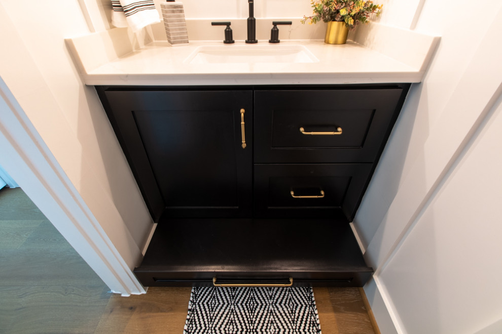 Design ideas for a small transitional powder room in Houston with shaker cabinets, black cabinets, an undermount sink, engineered quartz benchtops, black benchtops and a built-in vanity.