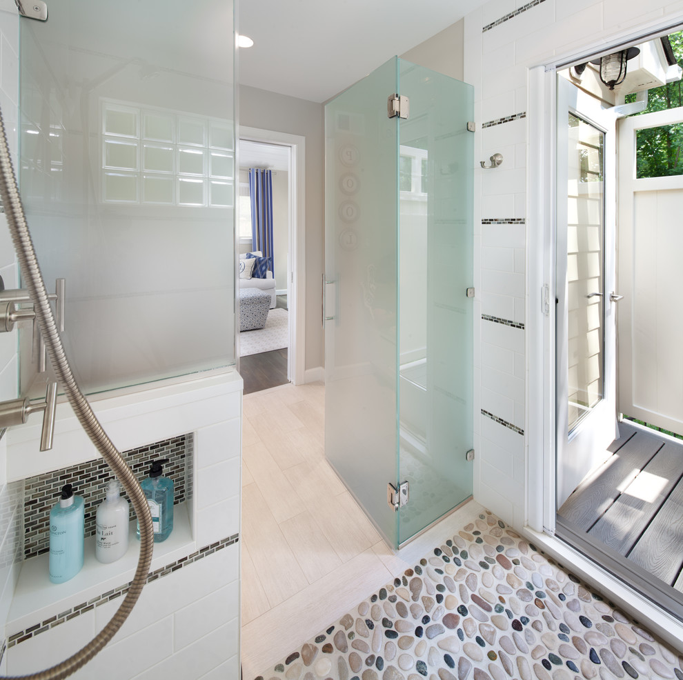This is an example of a mid-sized beach style bathroom in DC Metro with a curbless shower, ceramic floors, beige tile, mosaic tile and beige walls.