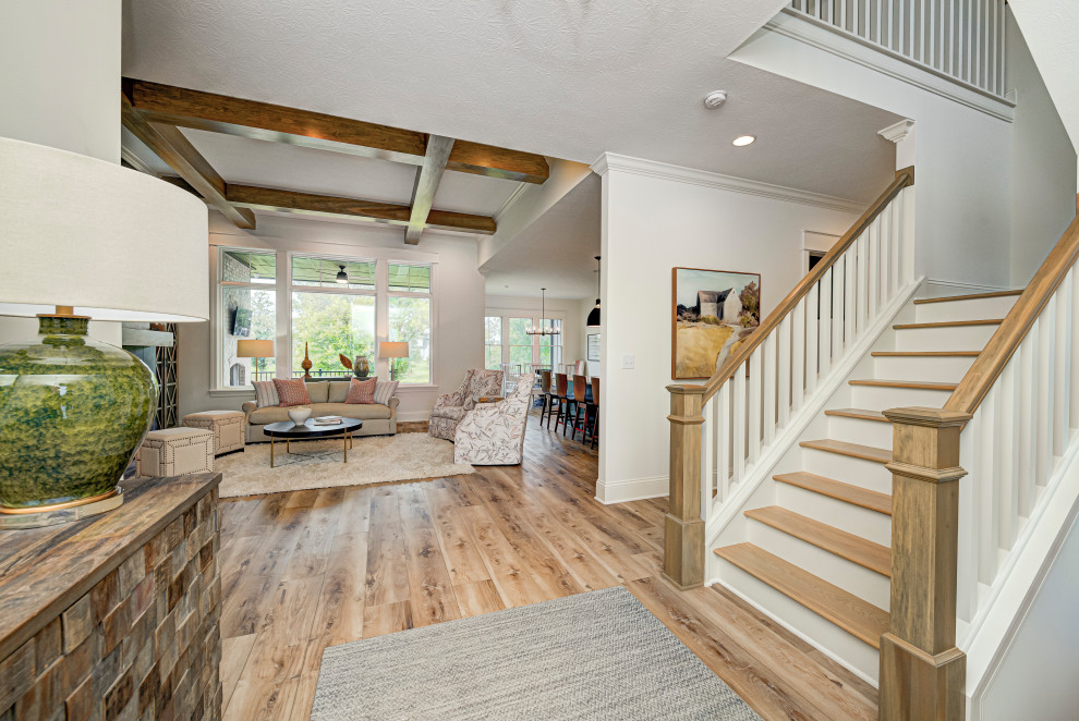 Inspiration for a mid-sized transitional vinyl floor and brown floor foyer remodel in Indianapolis with white walls and a gray front door