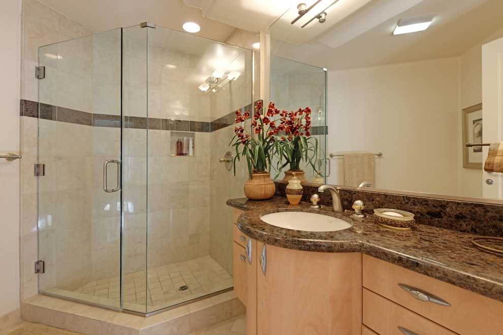 This is an example of a mid-sized contemporary 3/4 bathroom in San Diego with an undermount sink, flat-panel cabinets, light wood cabinets, granite benchtops, a corner shower, a one-piece toilet, white tile, porcelain tile, white walls and porcelain floors.