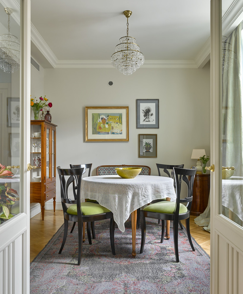 Inspiration for a traditional separate dining room in Moscow with beige walls and light hardwood floors.