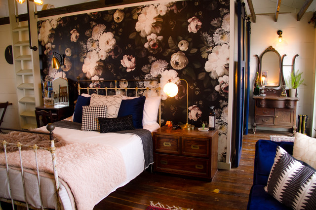 Example of a large farmhouse master dark wood floor and brown floor bedroom design in Austin with white walls