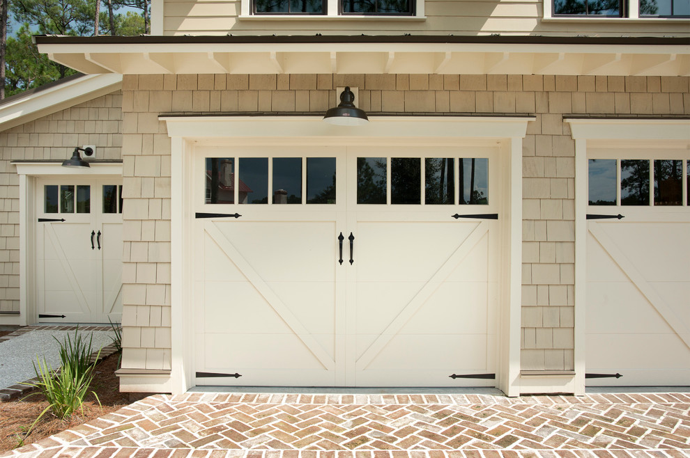 This is an example of a mid-sized beach style detached three-car garage in Atlanta.