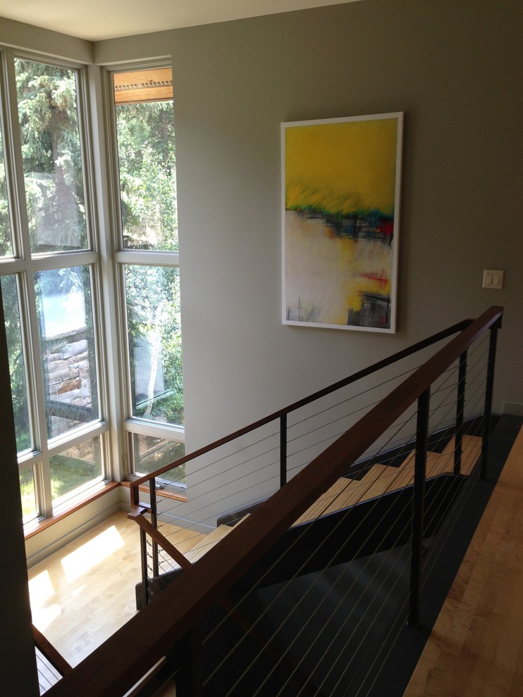 Design ideas for a large modern wood l-shaped staircase in Denver with metal risers and cable railing.