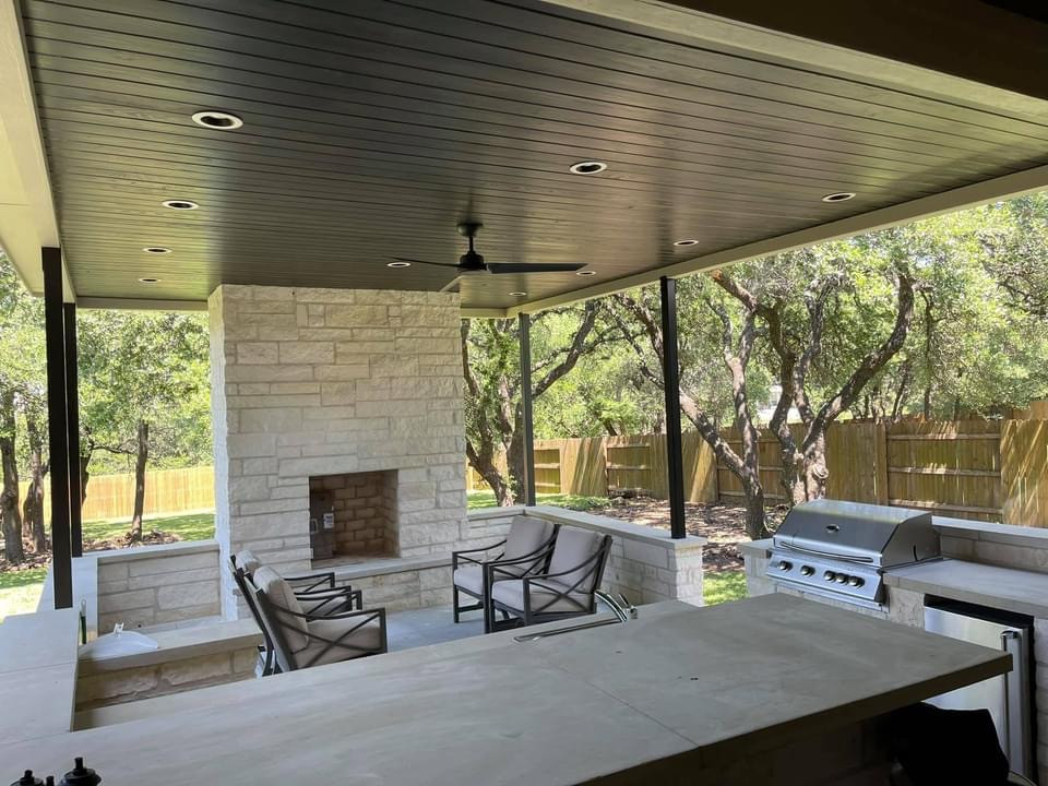 Inspiration for a small classic back fully shaded garden for summer in Austin with a fireplace and natural stone paving.