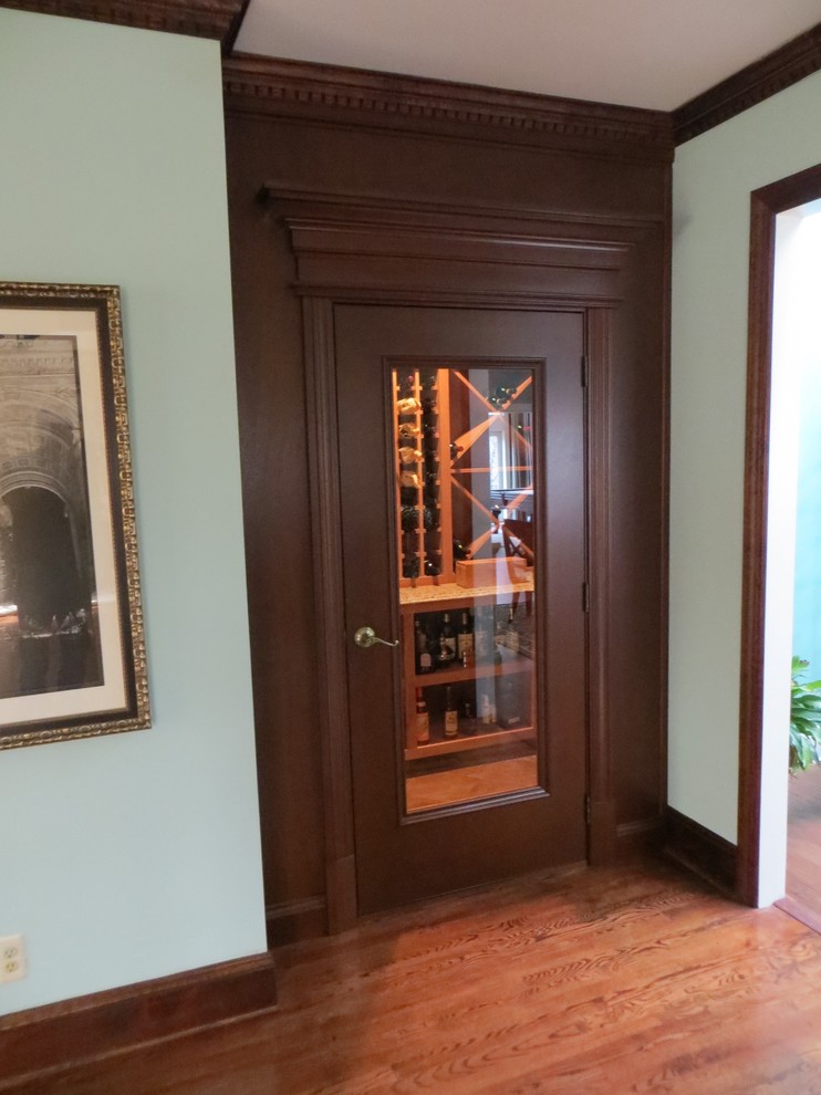 Design ideas for a mid-sized traditional wine cellar in Philadelphia with light hardwood floors and diamond bins.