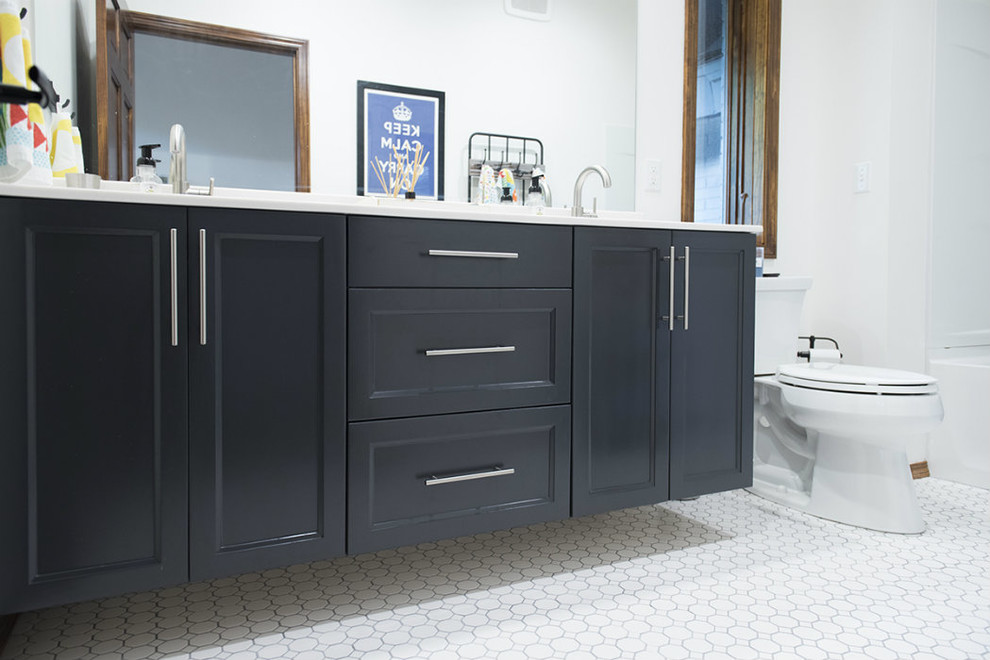 Bathroom - mid-sized transitional master porcelain tile and white floor bathroom idea with recessed-panel cabinets, black cabinets, a two-piece toilet, white walls and an undermount sink