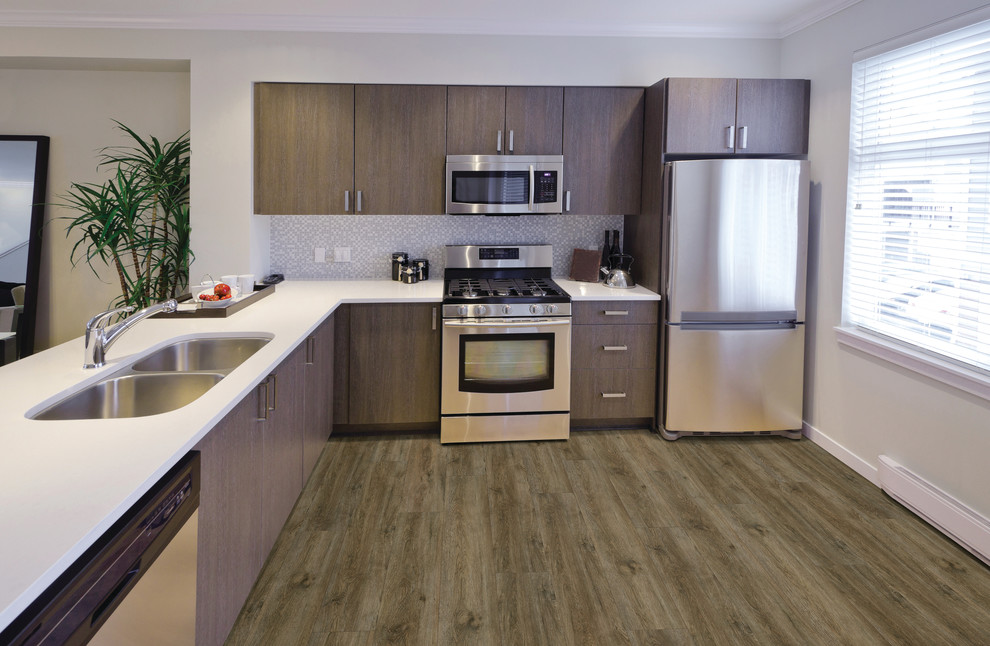 Example of a mid-sized transitional l-shaped light wood floor enclosed kitchen design with a double-bowl sink, flat-panel cabinets, medium tone wood cabinets, quartz countertops, multicolored backsplash, mosaic tile backsplash, stainless steel appliances and a peninsula