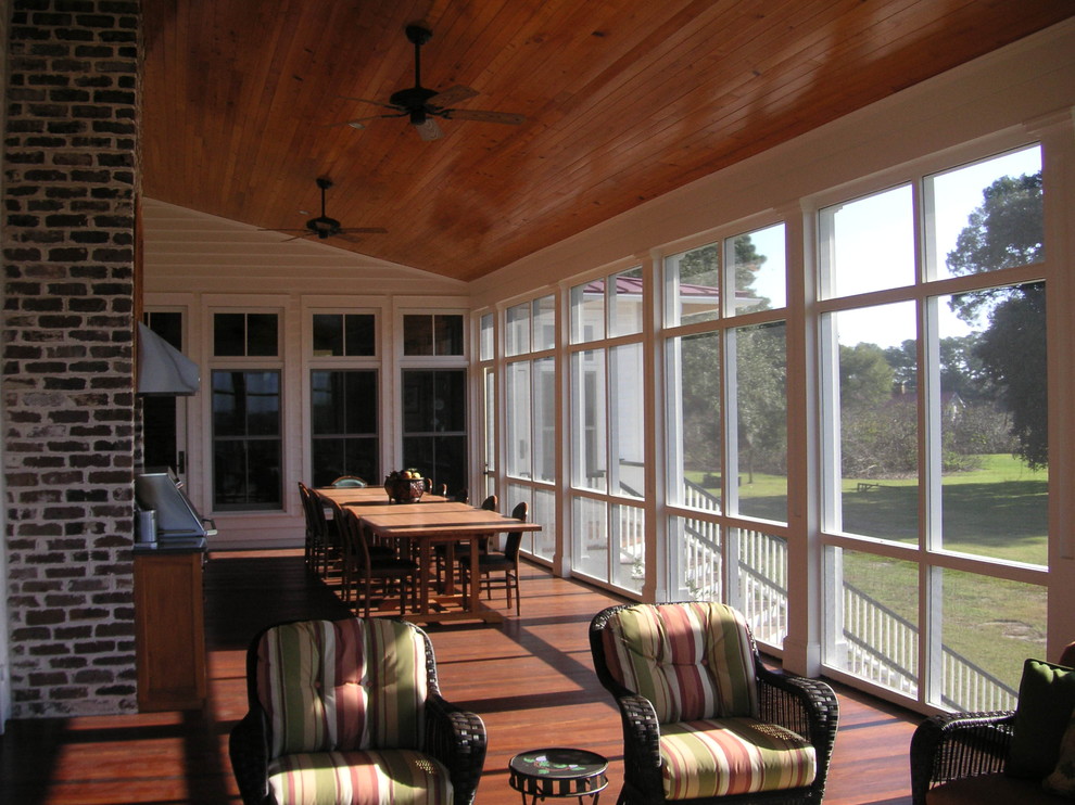 Large traditional verandah in Atlanta with an outdoor kitchen and a roof extension.