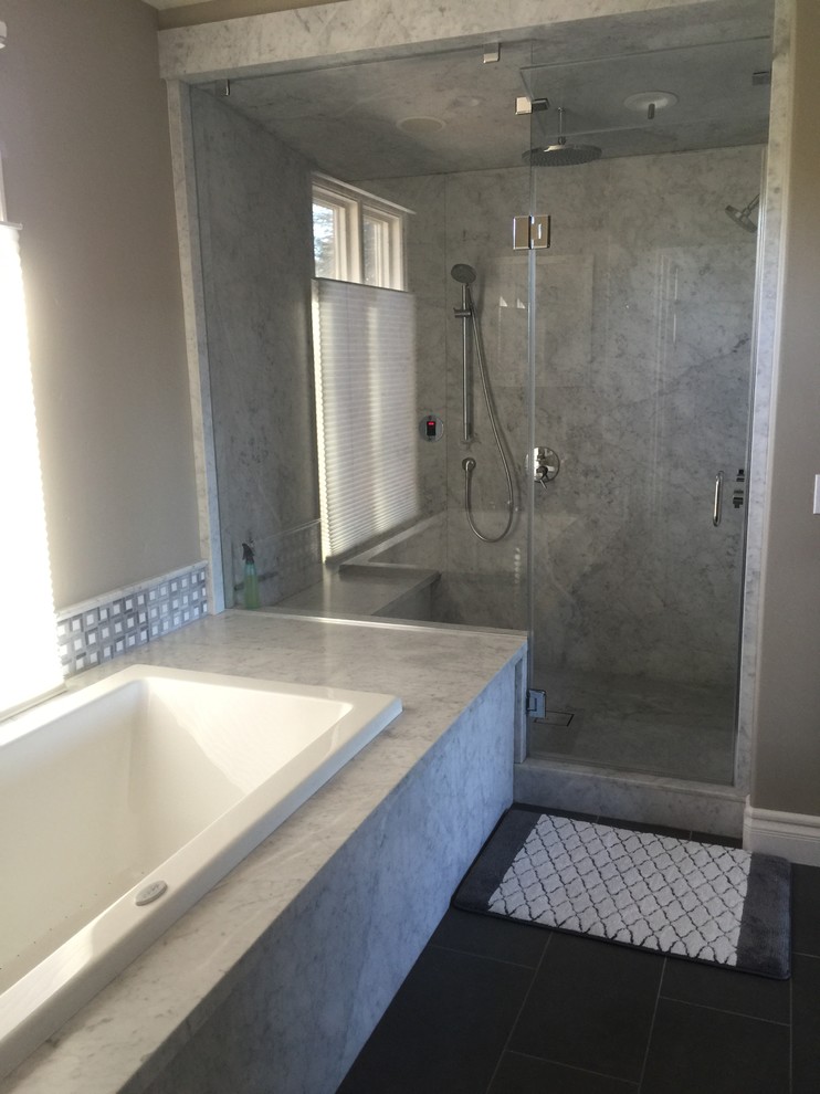 Design ideas for a large contemporary master bathroom in San Francisco with a drop-in tub, an alcove shower, a two-piece toilet, multi-coloured tile, stone slab, grey walls, porcelain floors, an undermount sink, marble benchtops, recessed-panel cabinets and white cabinets.