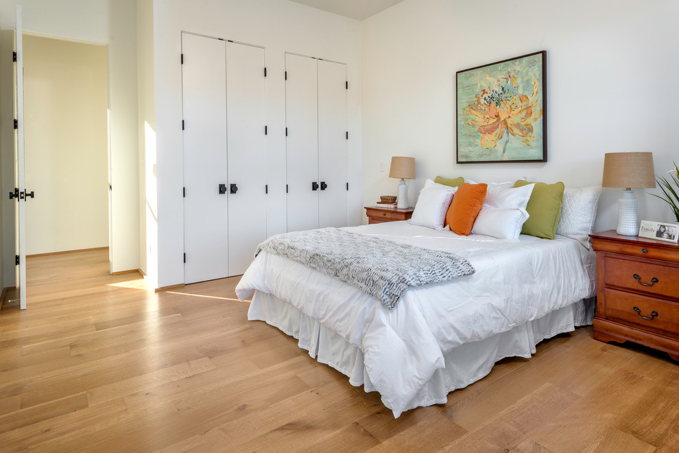 Inspiration for a cottage guest light wood floor bedroom remodel in San Francisco with white walls and no fireplace