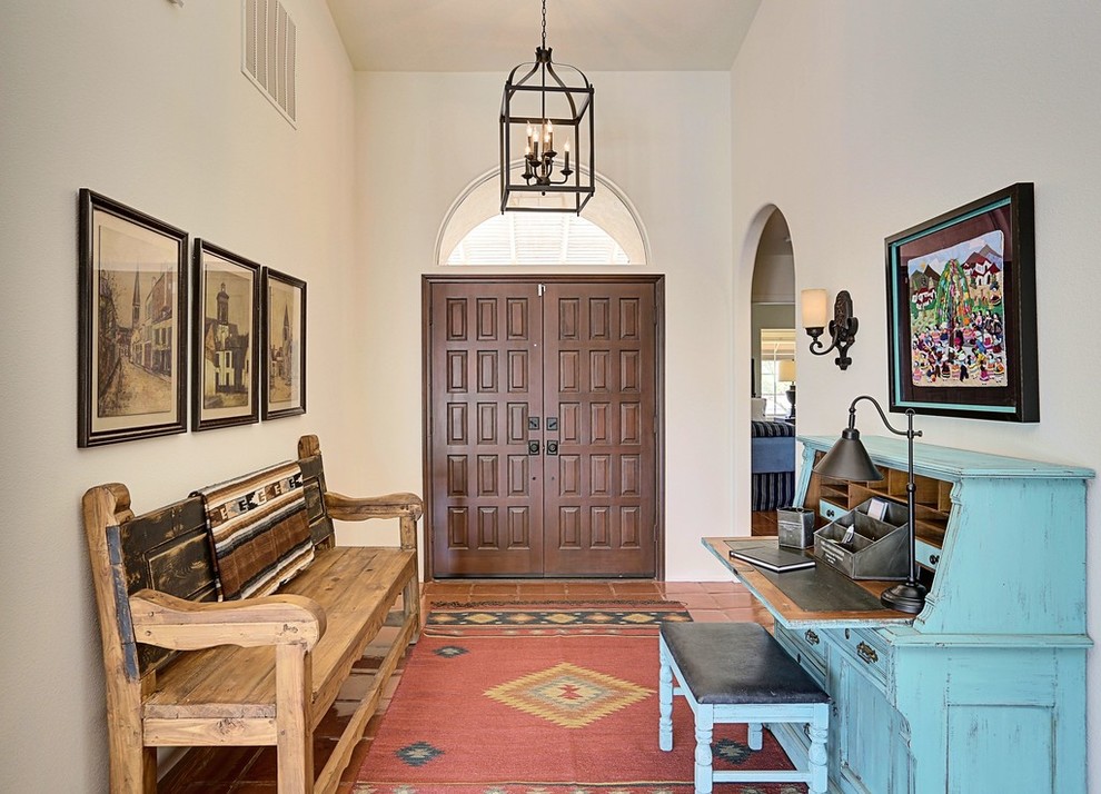 This is an example of a mid-sized foyer in Los Angeles with a double front door and a brown front door.