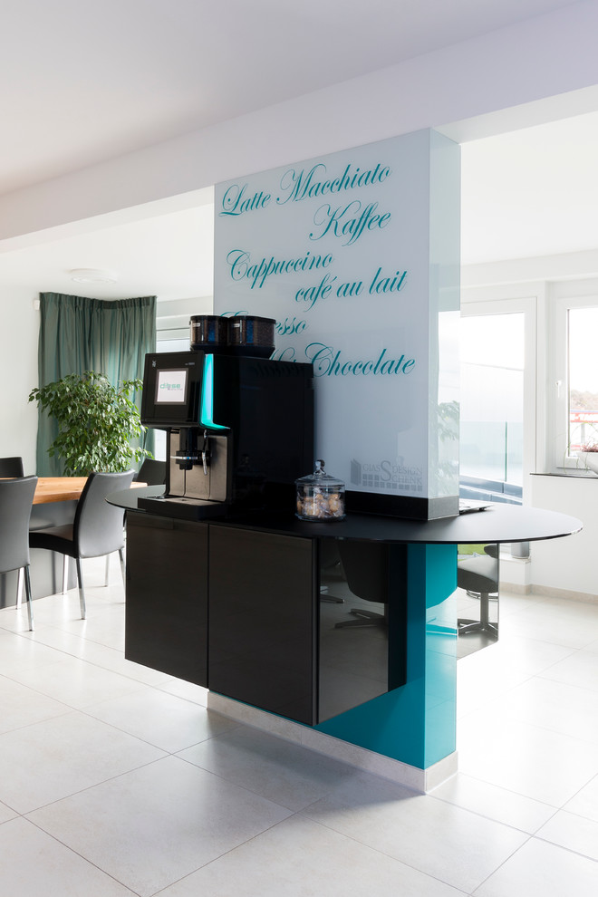 Küche mit Unterbauwaschbecken, Glasfronten, grauen Schränken, Glas-Arbeitsplatte, Küchenrückwand in Grün, Glasrückwand, Elektrogeräten mit Frontblende, Zementfliesen für Boden und Kücheninsel in Hamburg