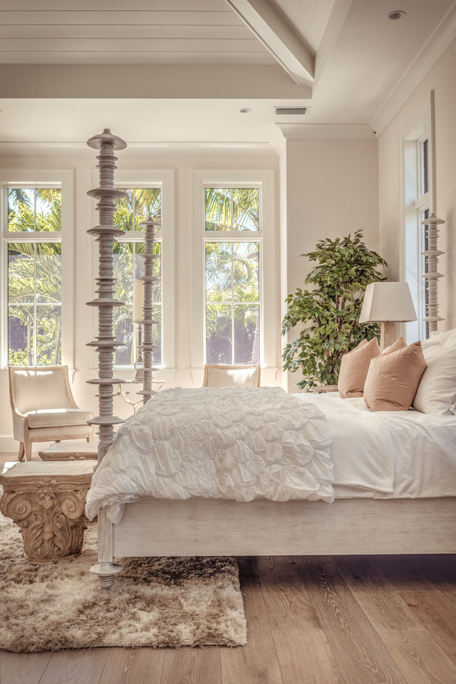 Inspiration for a transitional bedroom in Miami with white walls and medium hardwood floors.
