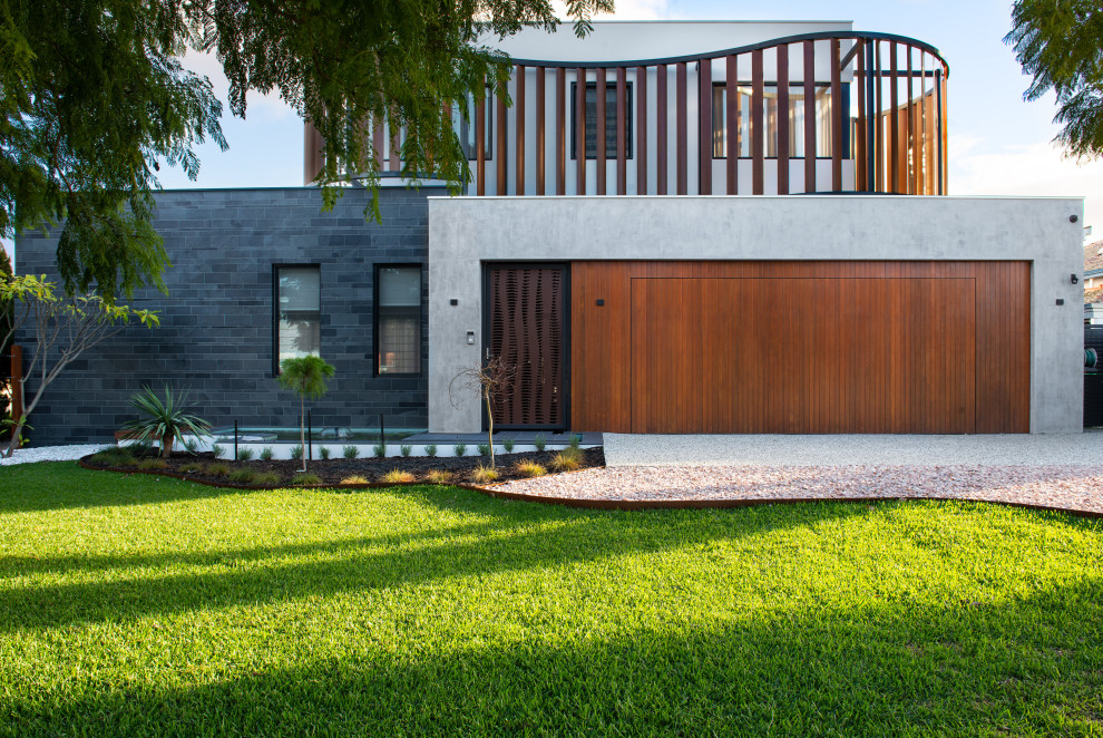 Large contemporary two-storey grey house exterior in Perth with stone veneer, a flat roof, a metal roof and a grey roof.
