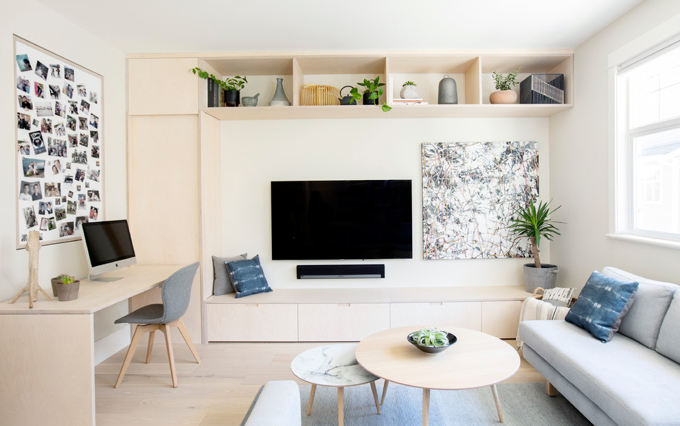 Small scandinavian family room in Vancouver with grey walls, light hardwood floors and a wall-mounted tv.