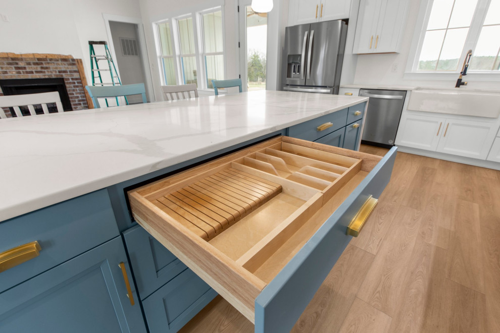 Large transitional l-shaped open concept kitchen photo in Richmond with a farmhouse sink, recessed-panel cabinets, quartz countertops, white backsplash, stainless steel appliances, an island and white countertops