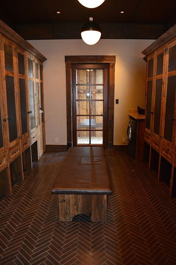 Mid-sized mountain style ceramic tile mudroom photo in Denver with beige walls and a dark wood front door