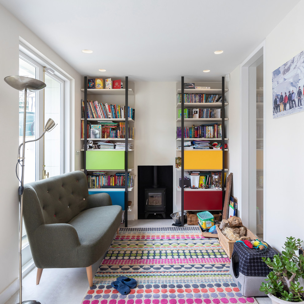This is an example of a transitional kids' room in London with white walls and white floor.