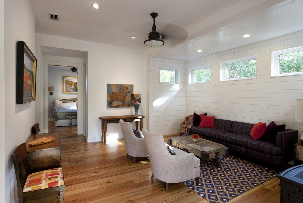 This is an example of a mid-sized country living room in Austin with white walls.