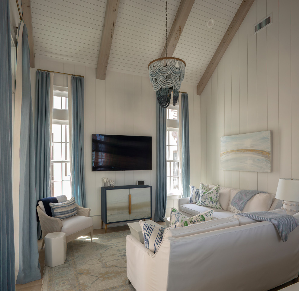 Example of a mid-sized beach style open concept beige floor, exposed beam, shiplap ceiling, vaulted ceiling, shiplap wall and medium tone wood floor family room design in Other with white walls and a wall-mounted tv