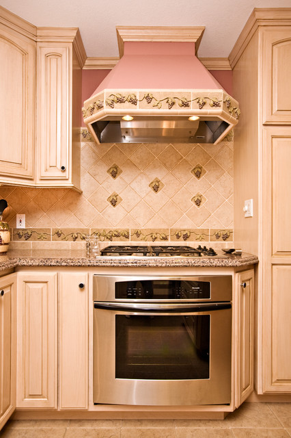 Wine themed kitchen with wine cooler and grape tile details