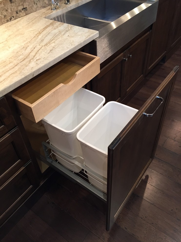 Inspiration for a mid-sized transitional kitchen remodel in Austin with a farmhouse sink, dark wood cabinets, beige backsplash, stone tile backsplash and stainless steel appliances