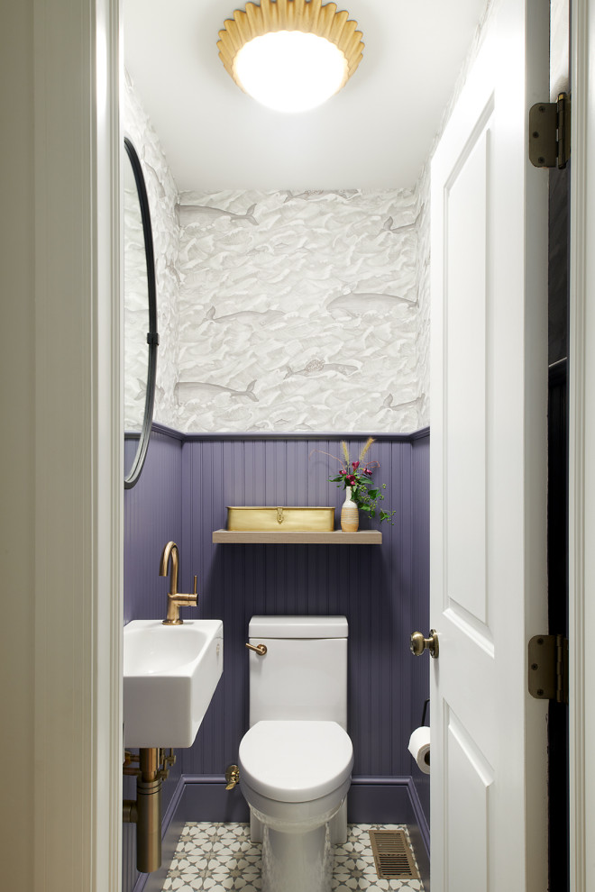 Inspiration for a small transitional powder room in Philadelphia with a two-piece toilet, multi-coloured walls, a wall-mount sink, multi-coloured floor and wallpaper.