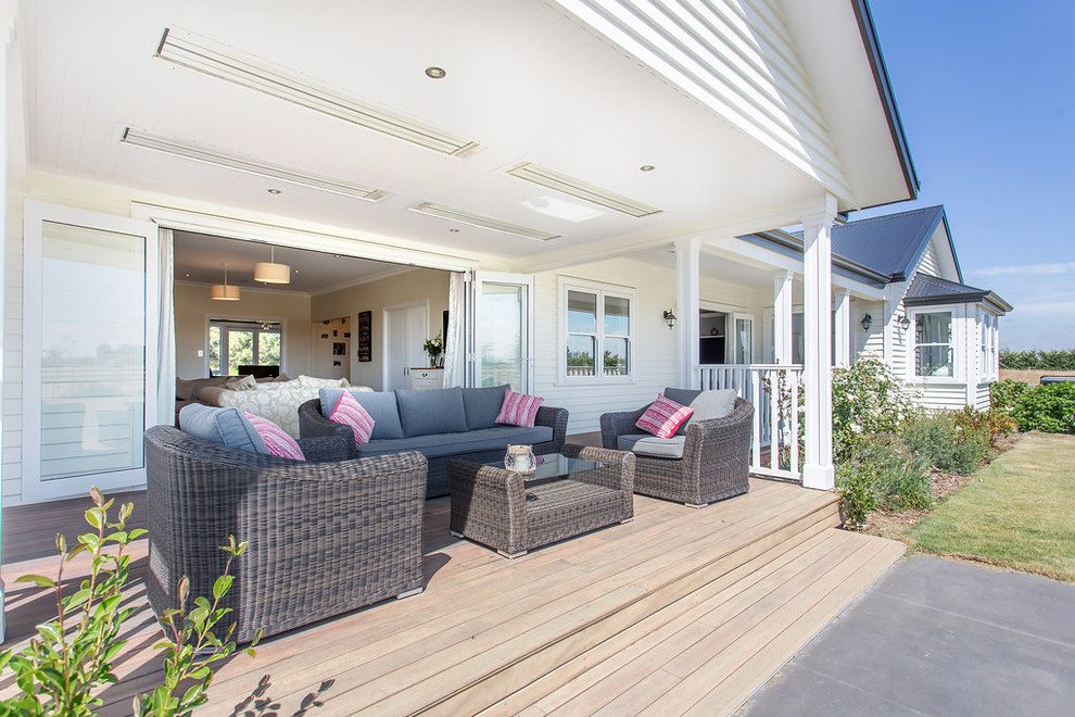 Inspiration for a large country backyard deck in Christchurch with a roof extension.