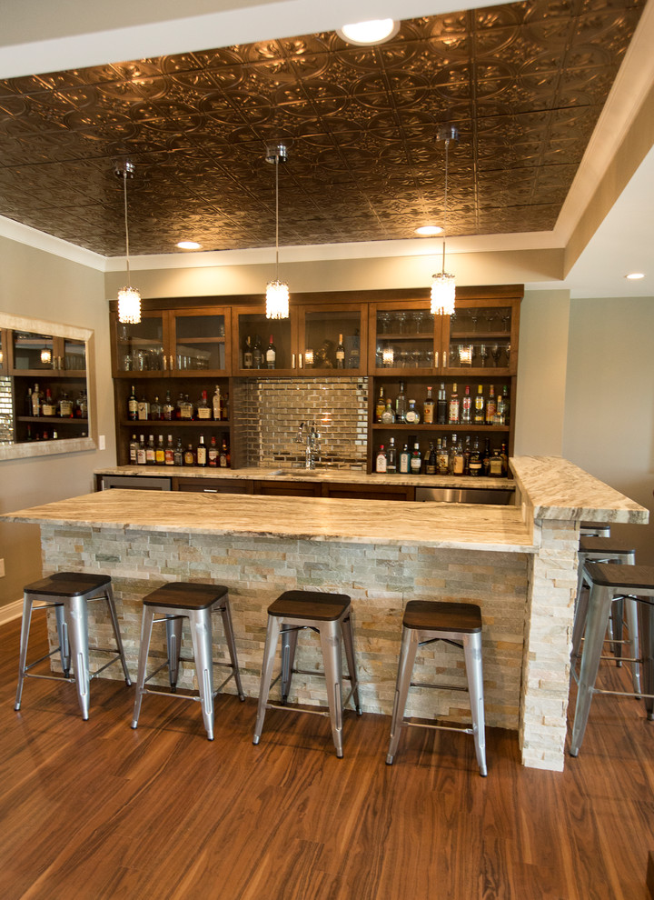 This is an example of a large eclectic home bar in Chicago with vinyl floors and brown floor.