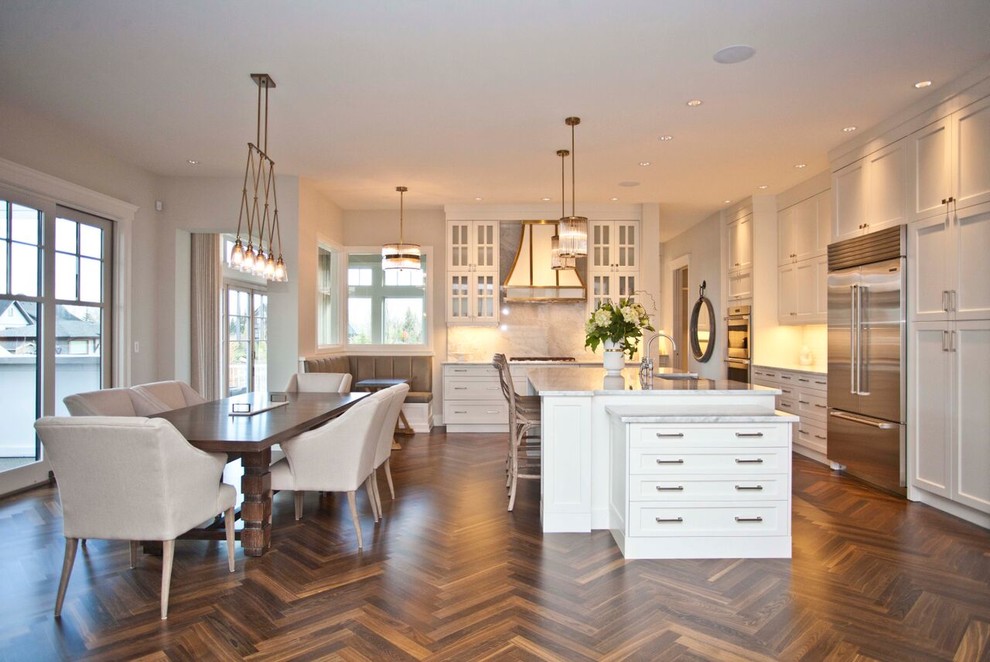 Open concept kitchen - large transitional l-shaped medium tone wood floor open concept kitchen idea in Calgary with shaker cabinets, white cabinets, marble countertops, stainless steel appliances and an island