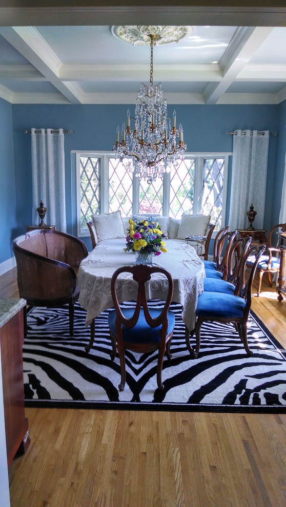 This is an example of a mid-sized traditional separate dining room in New York with blue walls and light hardwood floors.