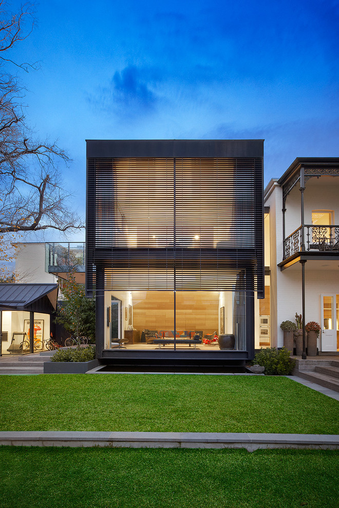Inspiration for a large contemporary two-storey exterior in Melbourne with a flat roof.