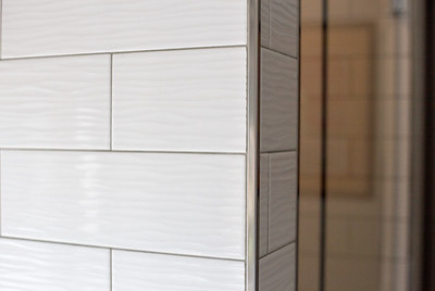 Inspiration for a mid-sized rustic master gray tile and subway tile concrete floor and gray floor home design remodel with shaker cabinets, white cabinets, a two-piece toilet, an undermount sink, granite countertops and a hinged shower door