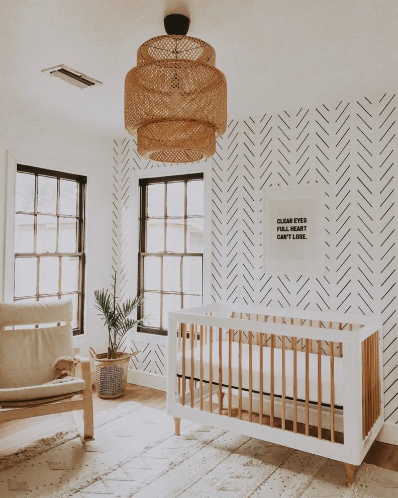 This is an example of a mid-sized scandinavian nursery for boys in Dallas with white walls, carpet and brown floor.
