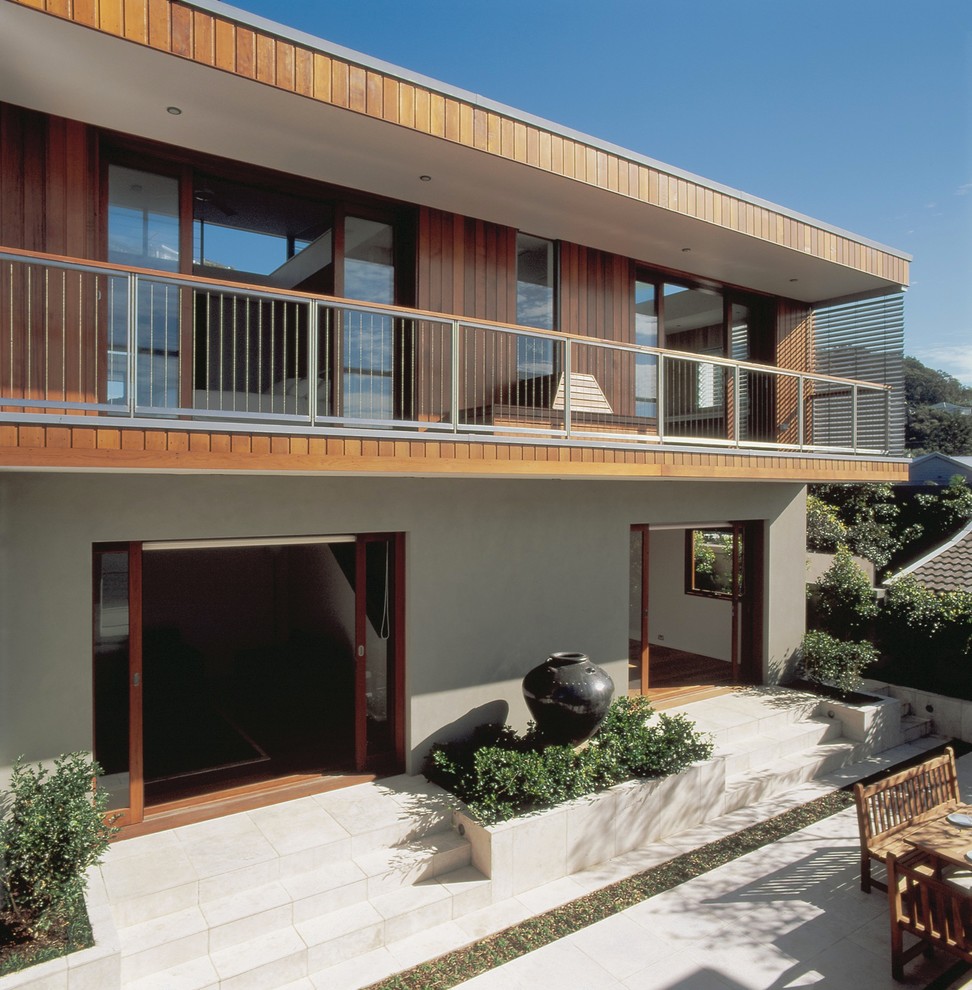 Design ideas for a contemporary three-storey brown exterior in Sydney with wood siding.