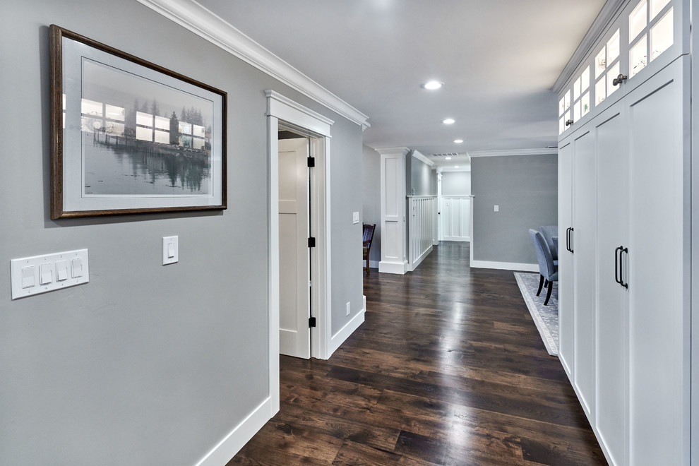 Design ideas for a large transitional hallway in San Francisco with grey walls and dark hardwood floors.