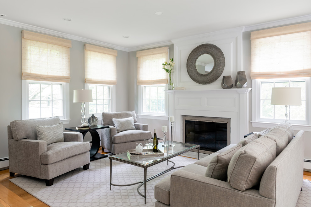 Photo of a large transitional open concept living room in Boston with grey walls, medium hardwood floors, a standard fireplace, brown floor, a music area, a wood fireplace surround and no tv.