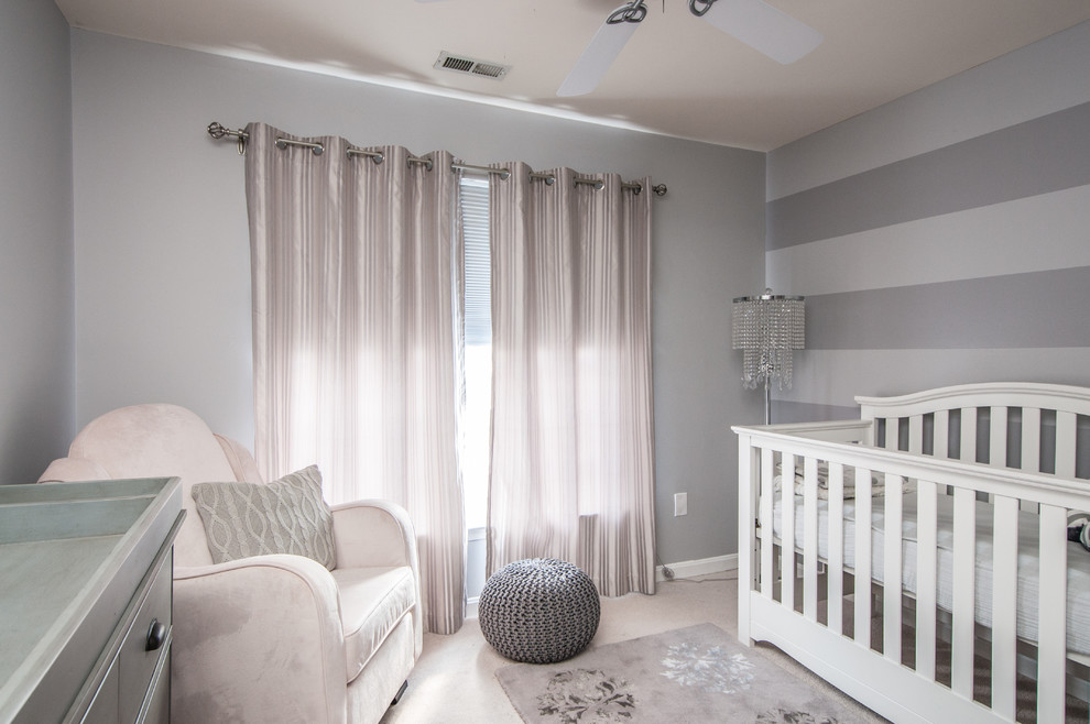 Photo of a traditional nursery for girls in DC Metro with grey walls and carpet.