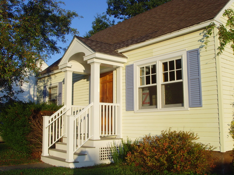 Mid-sized classic front porch idea in Burlington with a roof extension