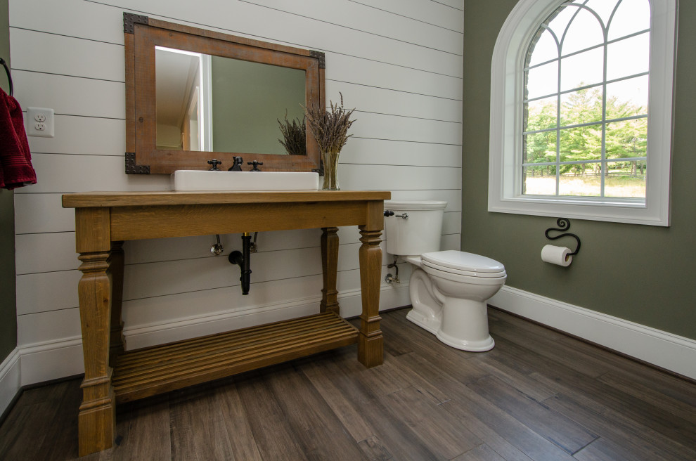 This is an example of an expansive country bathroom in DC Metro with light wood cabinets, a two-piece toilet, white walls, dark hardwood floors, wood benchtops, grey floor, a single vanity, a freestanding vanity, planked wall panelling and a vessel sink.