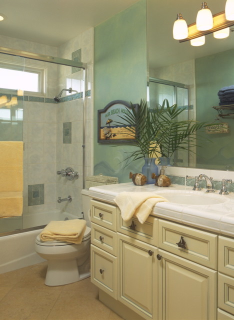 Example of a mid-sized island style kids' white tile and ceramic tile travertine floor bathroom design in San Diego with raised-panel cabinets, yellow cabinets, tile countertops, a one-piece toilet and blue walls