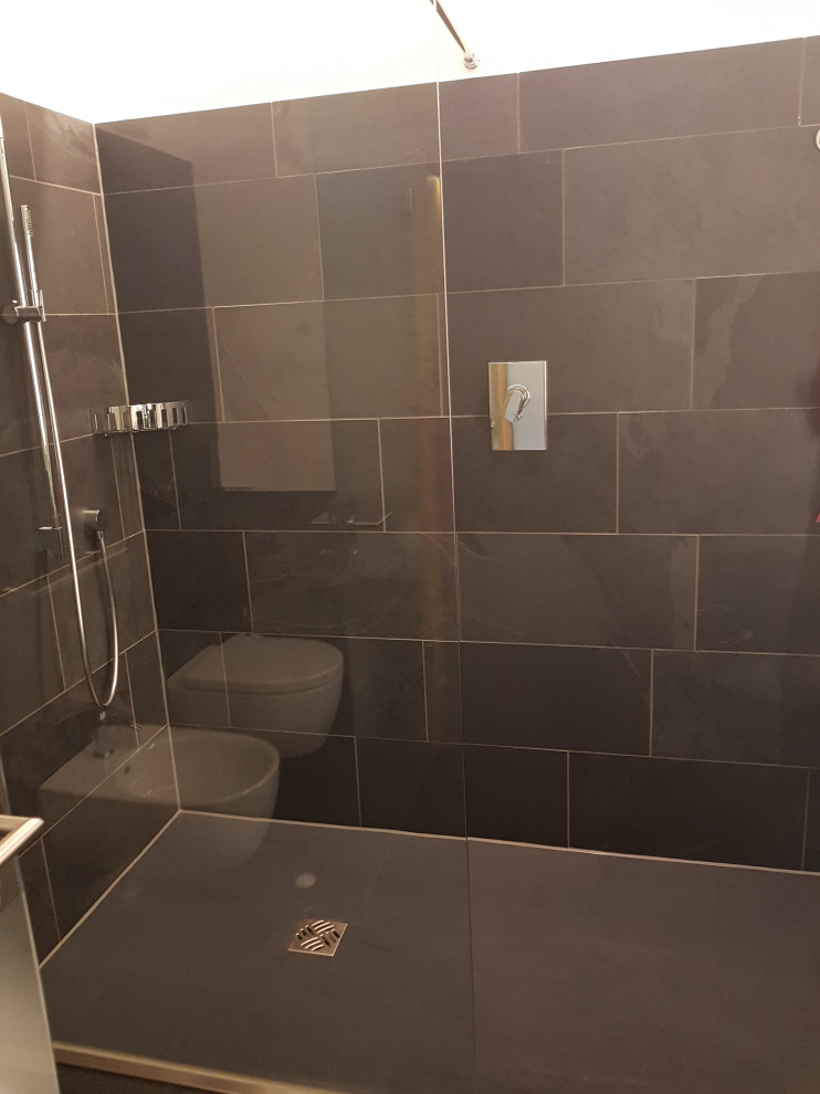 Mid-sized contemporary 3/4 bathroom in Munich with open cabinets, grey cabinets, a curbless shower, a two-piece toilet, gray tile, slate, grey walls, slate floors, a vessel sink, glass benchtops, grey floor, an open shower, grey benchtops, a single vanity and a freestanding vanity.