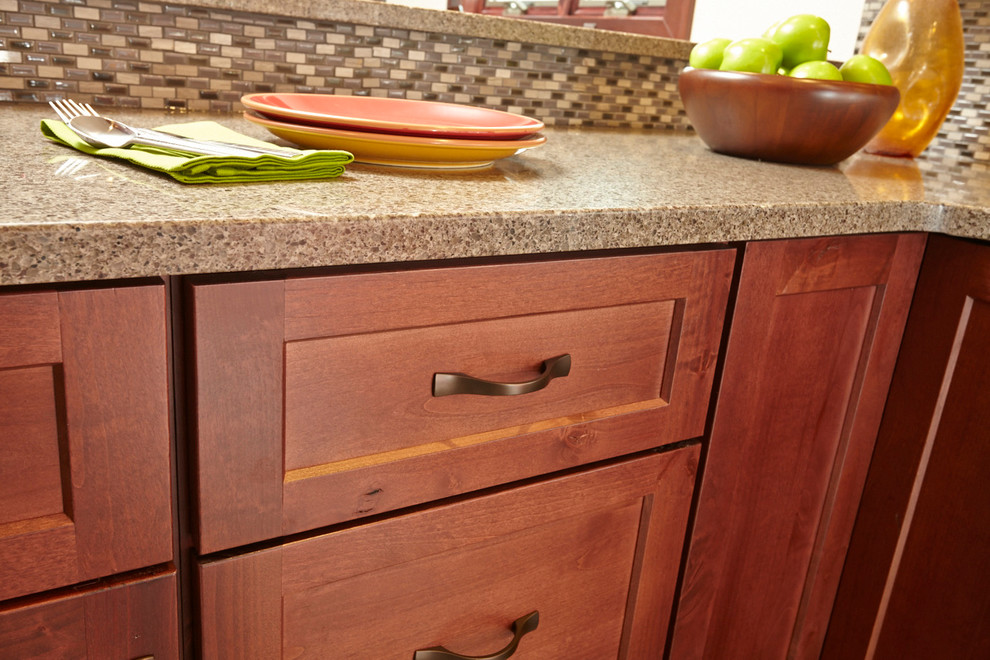 Example of a transitional u-shaped kitchen design with an undermount sink, shaker cabinets, medium tone wood cabinets, beige backsplash, glass sheet backsplash, stainless steel appliances and no island