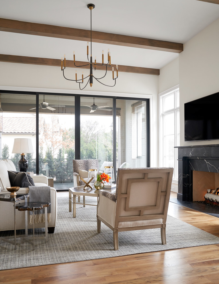 Photo of a mid-sized transitional open concept family room in Dallas with white walls, medium hardwood floors, a standard fireplace, a stone fireplace surround, a wall-mounted tv and beige floor.